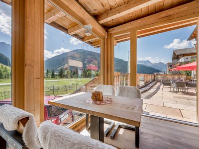 Our history • Der Grubacher: Eco Hotel in Gerlos Winter garden with cozy chairs and a view of the terrace