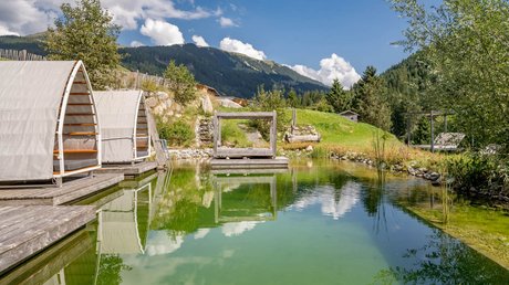 Pictures & Impressions • Der Grubacher: Hotel in Gerlos Swimming pond in the garden with sun lounger and view of the mountains