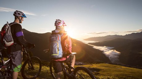 Pictures & Impressions • Der Grubacher: Hotel in Gerlos Couple with bicycle in the mountains at dawn